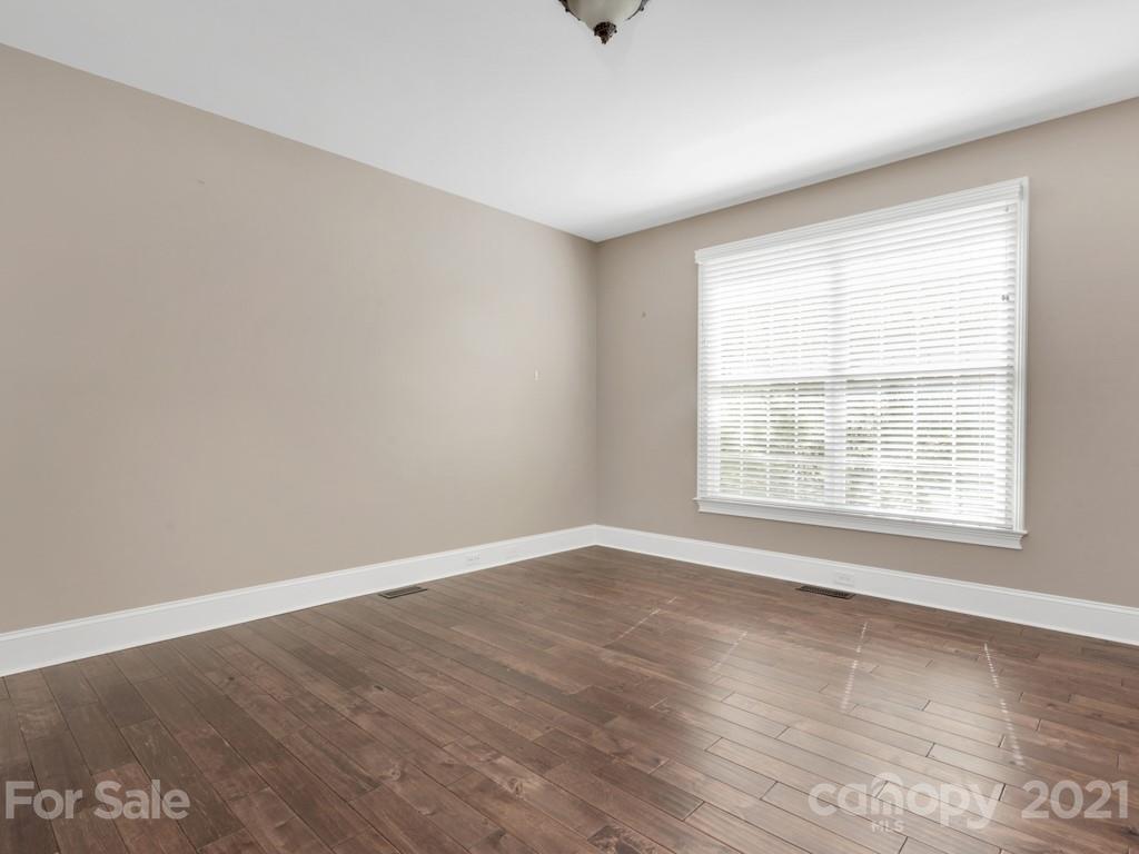 225 Cattle Ridge Road Marvin, NC 28173 - Photo 18 of 42 an empty room with wooden floor and windows