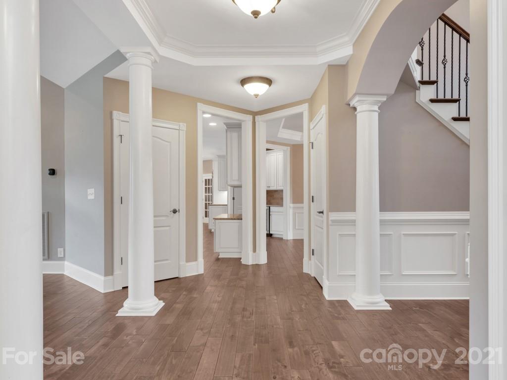 225 Cattle Ridge Road Marvin, NC 28173 - Photo 19 of 42 a view of a hallway with wooden floor and staircase