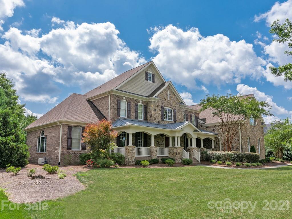225 Cattle Ridge Road Marvin, NC 28173 - Photo 3 of 42 a front view of a house with a garden
