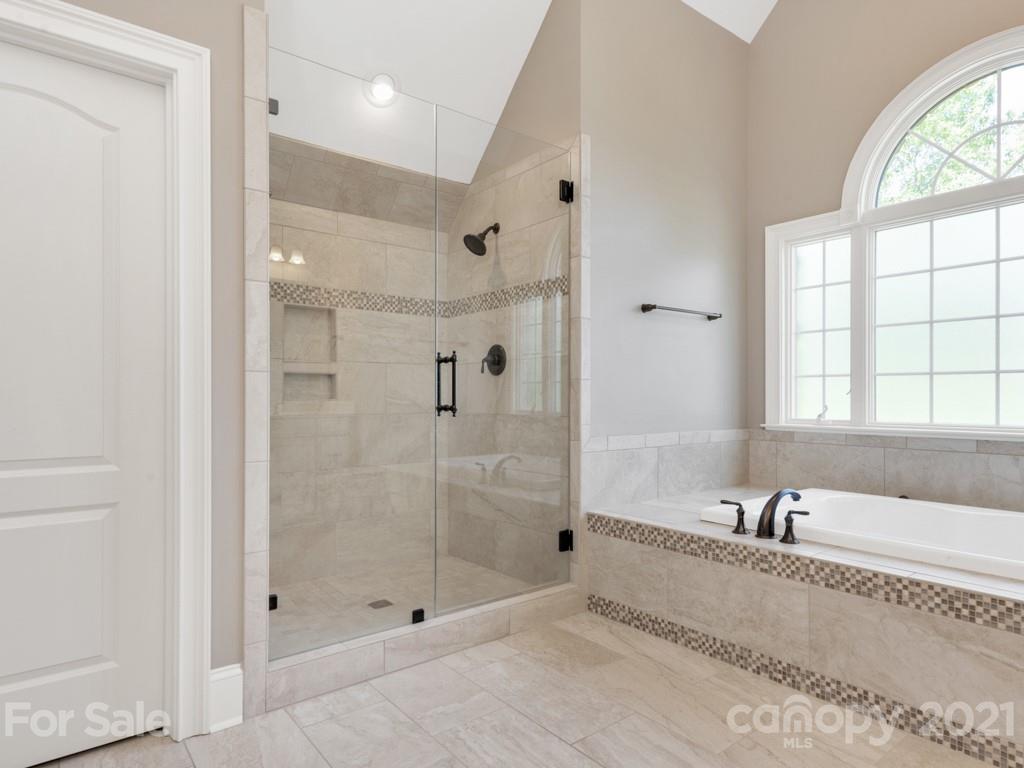 225 Cattle Ridge Road Marvin, NC 28173 - Photo 28 of 42 a bathroom with a granite countertop tub shower and mirror
