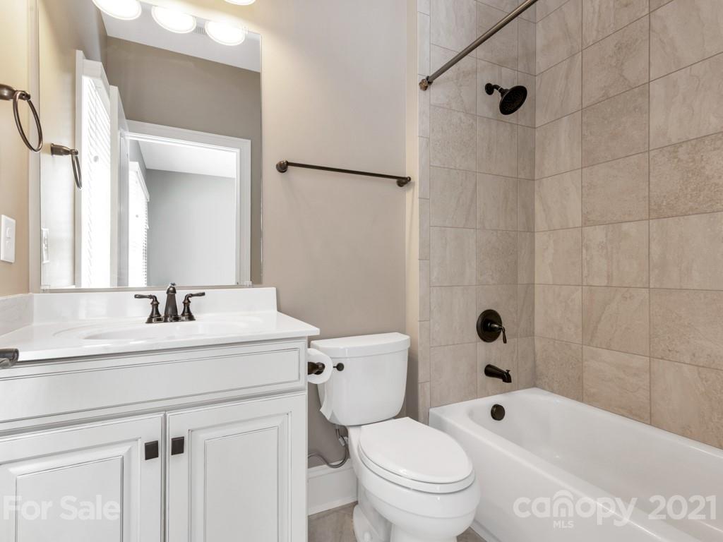 225 Cattle Ridge Road Marvin, NC 28173 - Photo 30 of 42 a bathroom with a sink a toilet and a mirror