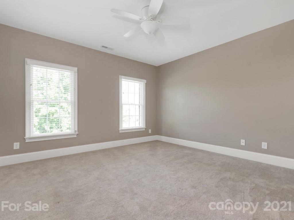 225 Cattle Ridge Road Marvin, NC 28173 - Photo 32 of 42 an empty room with a window and a fan