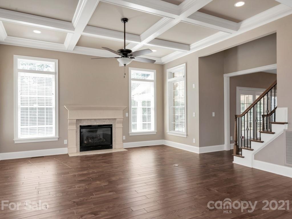 225 Cattle Ridge Road Marvin, NC 28173 - Photo 9 of 42 a view of an empty room with wooden floor fireplace and a window