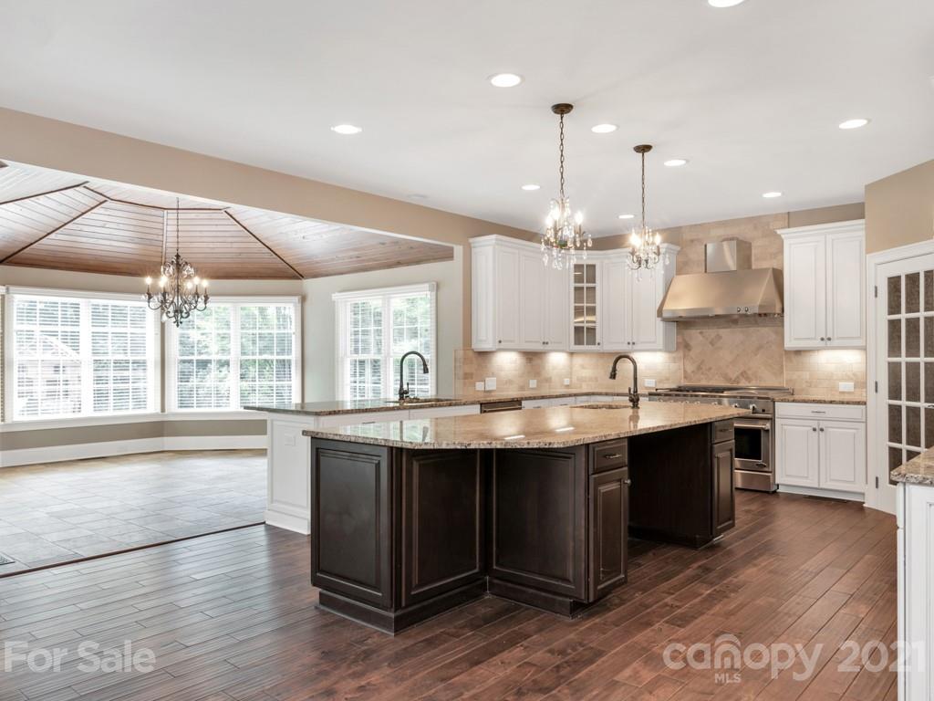 225 Cattle Ridge Road Marvin, NC 28173 - Photo 10 of 42 a large kitchen with kitchen island a sink stainless steel appliances and cabinets