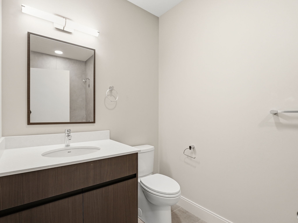 249 Corey Road, Unit 105 Boston, MA 02135 - Photo 12 of 41 a bathroom with a sink and a mirror