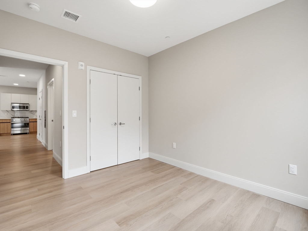 249 Corey Road, Unit 105 Boston, MA 02135 - Photo 15 of 41 a view of a hallway with wooden floor