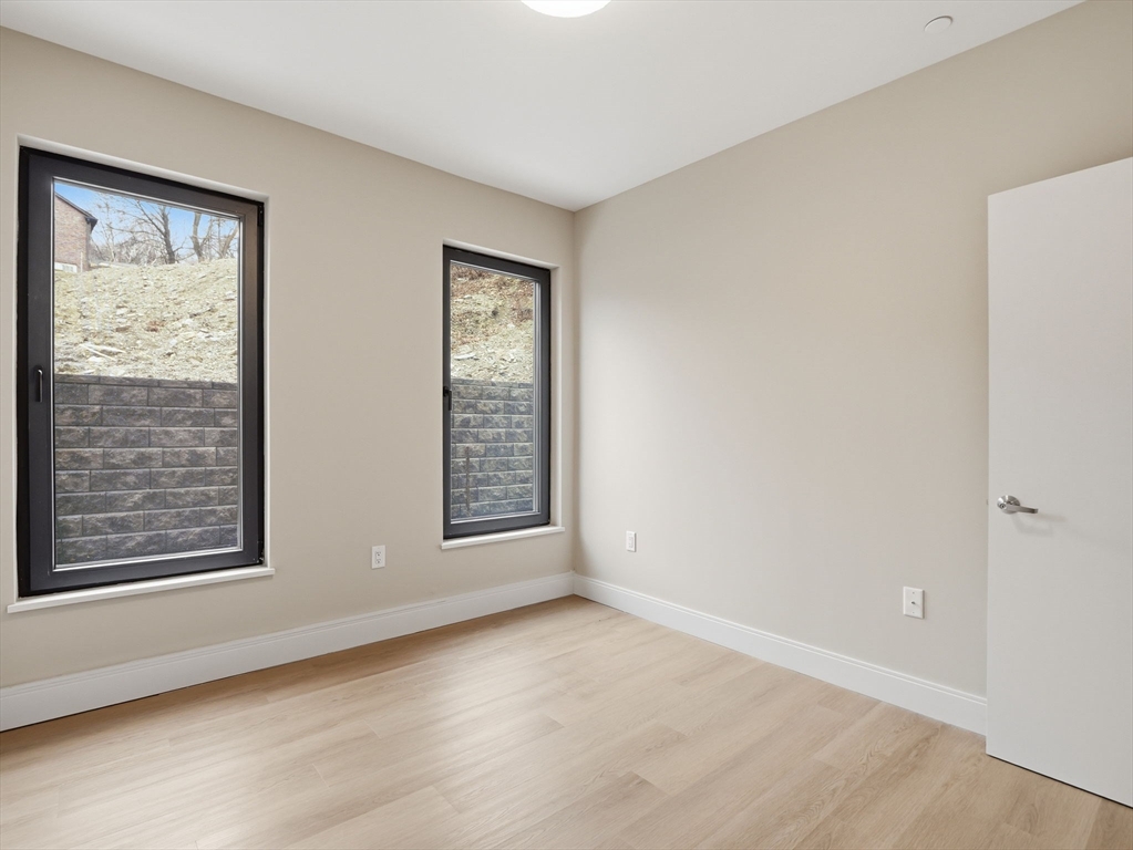 249 Corey Road, Unit 105 Boston, MA 02135 - Photo 17 of 41 a view of an empty room with windows