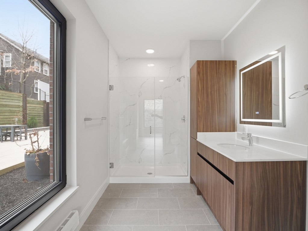 249 Corey Road, Unit 105 Boston, MA 02135 - Photo 23 of 41 a bathroom with a sink and a mirror