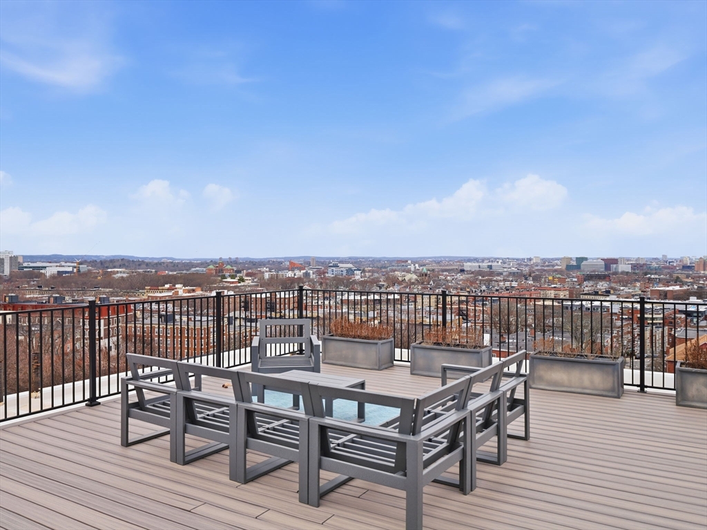 249 Corey Road, Unit 105 Boston, MA 02135 - Photo 26 of 41 a view of a terrace with wooden floor and city view