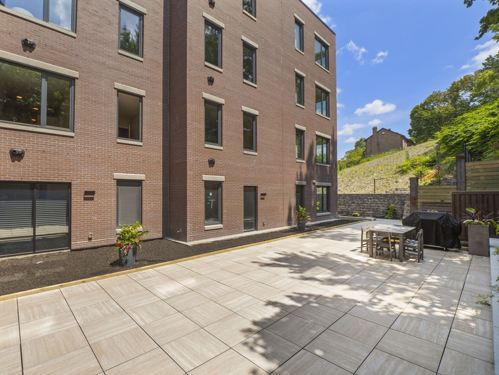 249 Corey Road, Unit 105 Boston, MA 02135 - Photo 38 of 41 a view of a building with sitting area