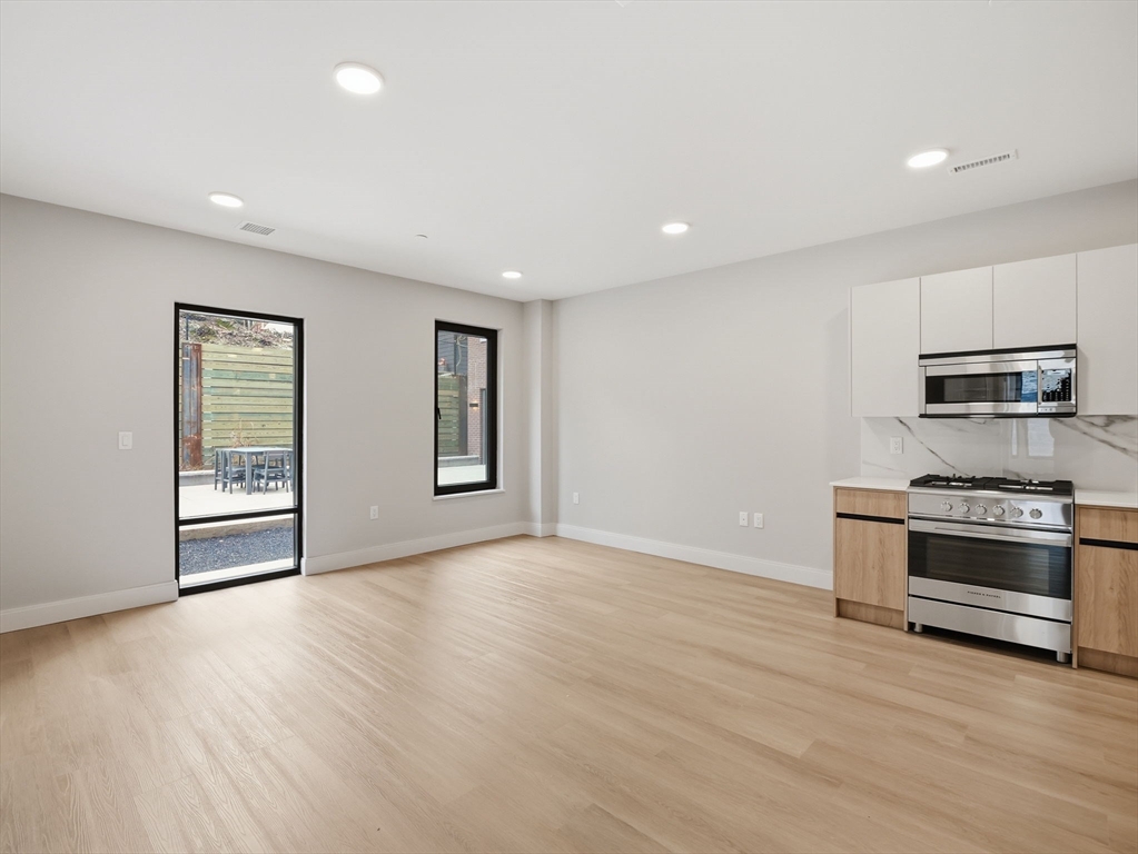 249 Corey Road, Unit 105 Boston, MA 02135 - Photo 6 of 41 a view of kitchen with microwave and stove