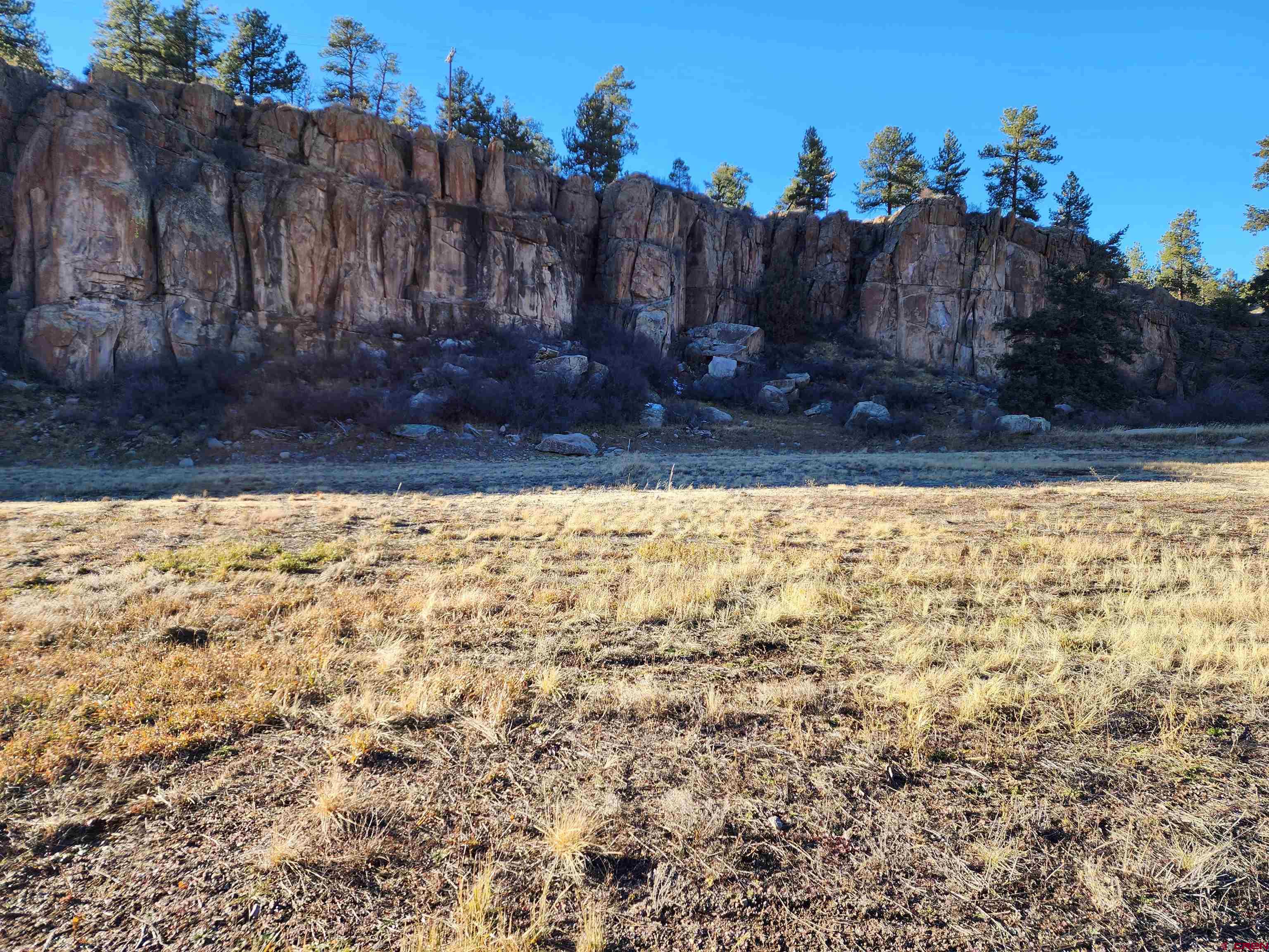 2 West R Highway South Fork, CO 81154 - Photo 4 of 8 a view of a backyard with wooden fence