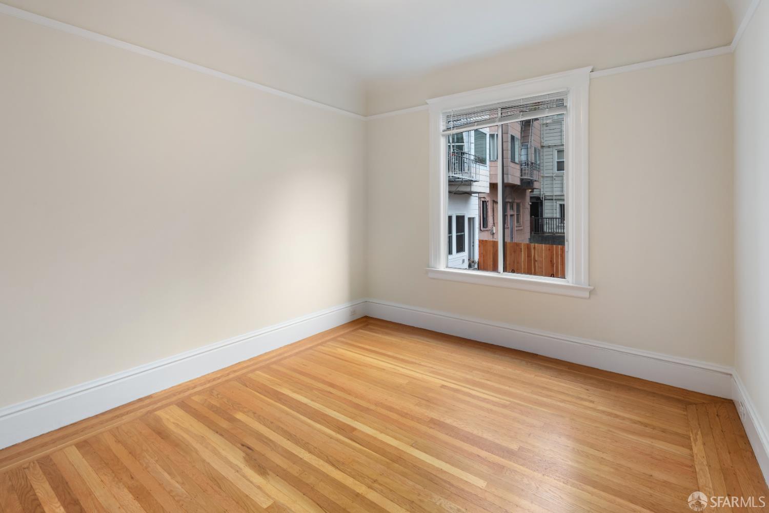1338 Larkin Street San Francisco, CA 94109 - Photo 17 of 56 a view of an empty room with wooden floor and a window
