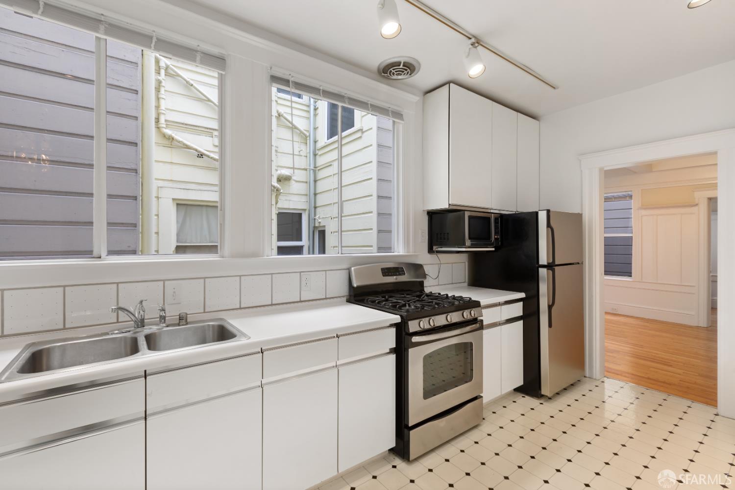 1338 Larkin Street San Francisco, CA 94109 - Photo 22 of 56 a kitchen with granite countertop a stove sink and refrigerator