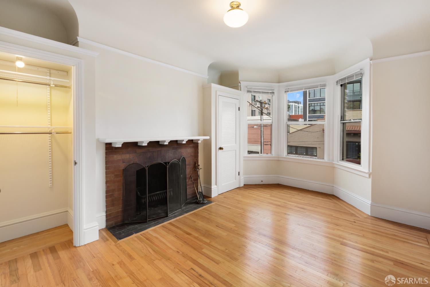 1338 Larkin Street San Francisco, CA 94109 - Photo 25 of 56 a view of an empty room with a fireplace and a window