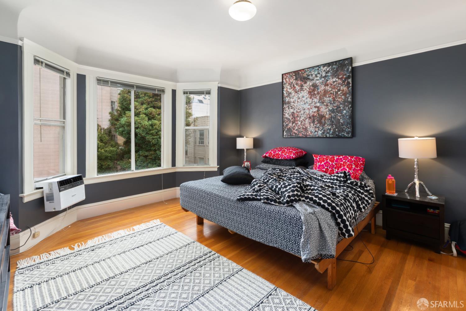 1338 Larkin Street San Francisco, CA 94109 - Photo 29 of 56 a bedroom with a bed painting on wall and a large window