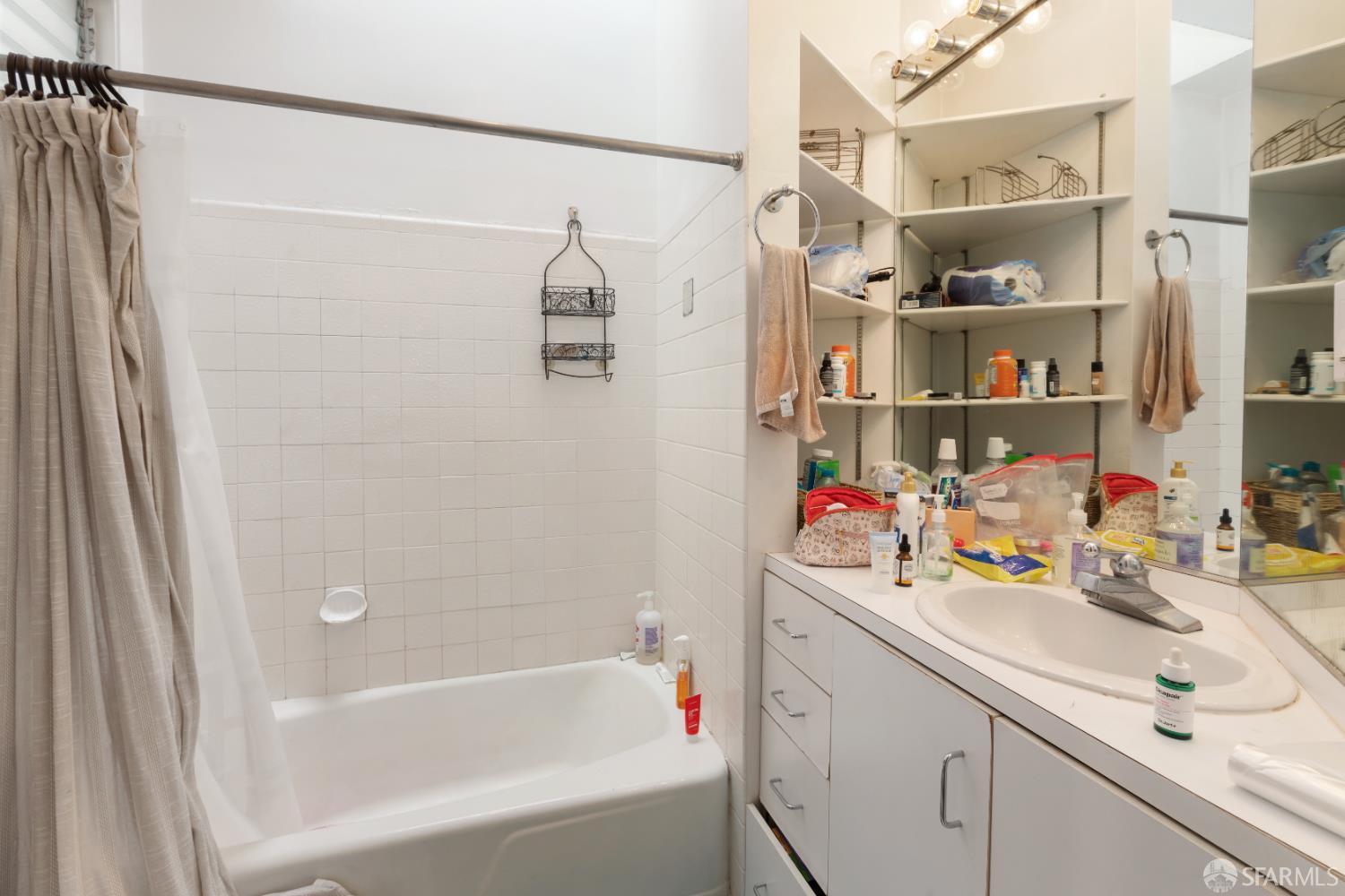 1338 Larkin Street San Francisco, CA 94109 - Photo 37 of 56 a bathroom with a sink a bath tub and shower
