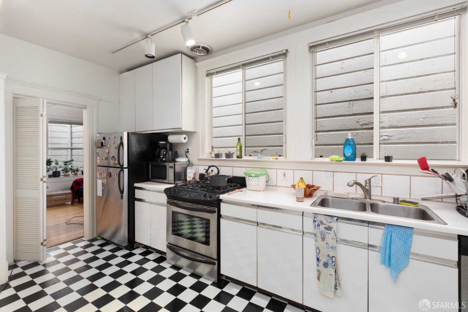 1338 Larkin Street San Francisco, CA 94109 - Photo 42 of 56 a kitchen with a sink stove and refrigerator