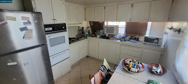 a kitchen with stainless steel appliances a stove a refrigerator and a sink