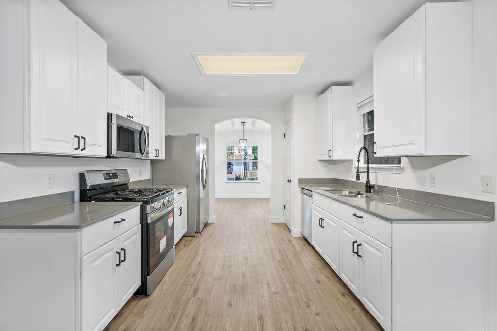 617 Barbara Way Bastrop, TX 78602 - Photo 2 of 20 Modern kitchen with white shaker cabinets and sleek appliances, perfect for culinary adventures.