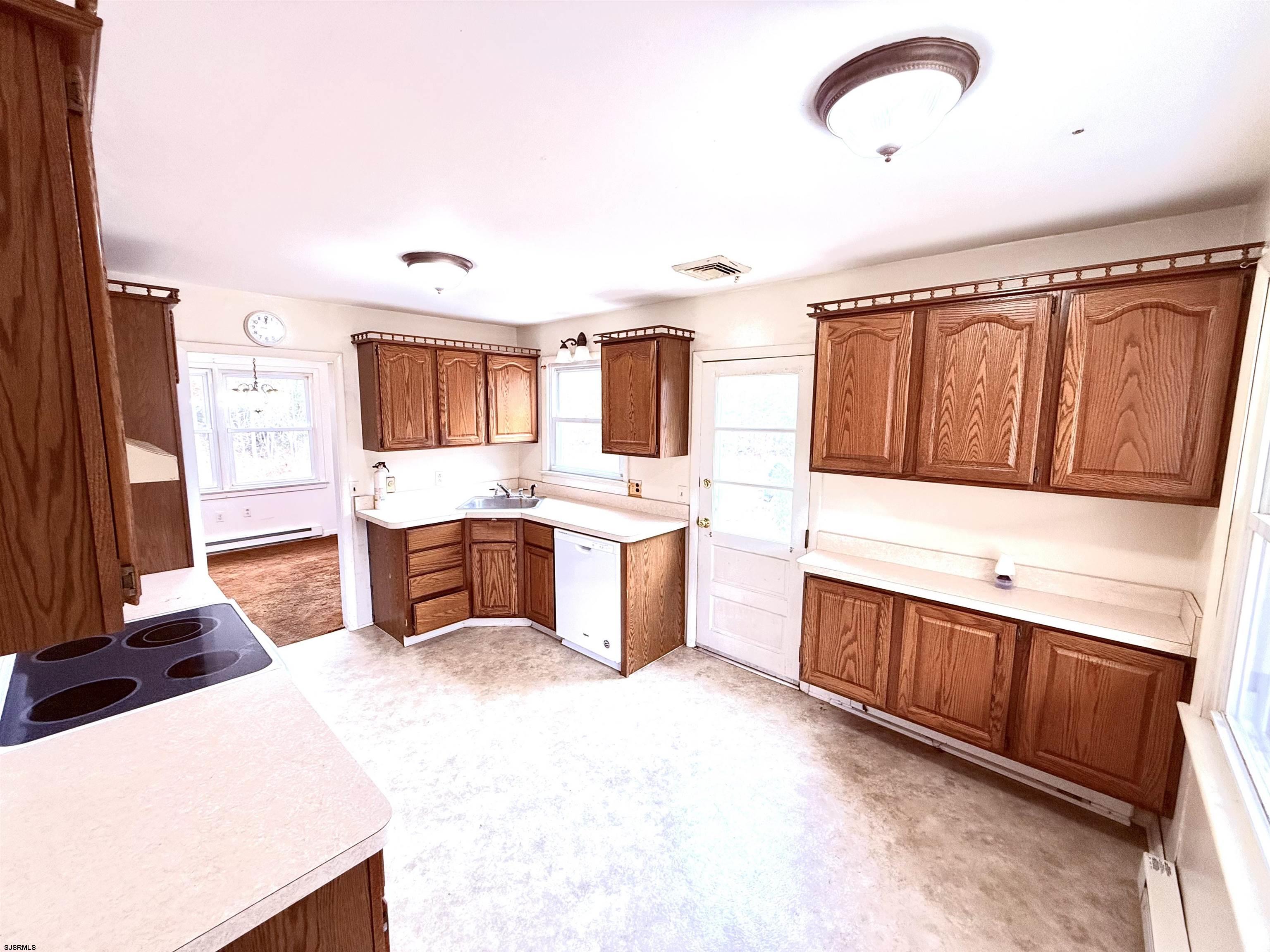 241 Mill Road Woodbine, NJ 08270 - Photo 15 of 31 a large kitchen with stainless steel appliances kitchen island granite countertop a sink and cabinets