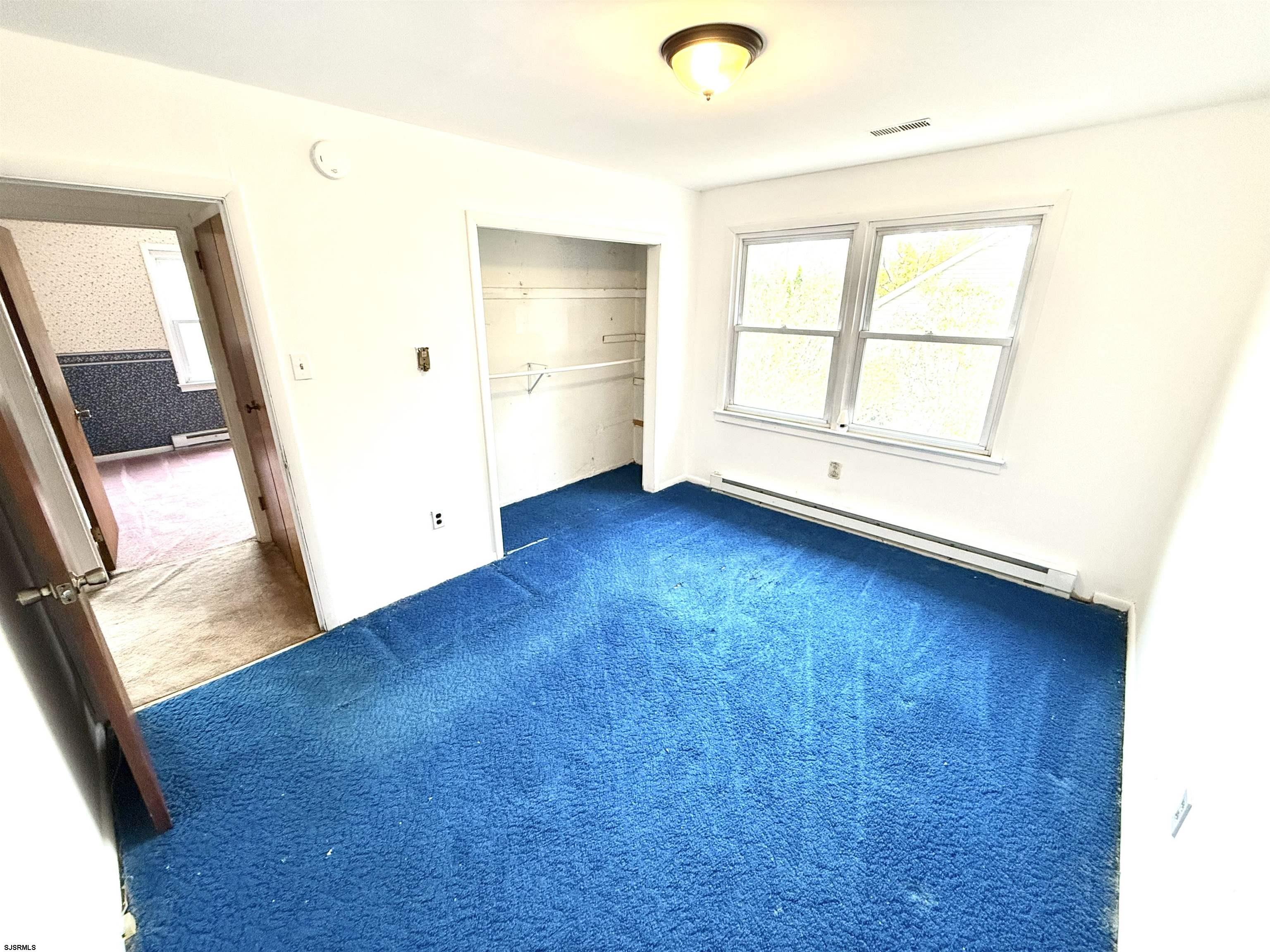 241 Mill Road Woodbine, NJ 08270 - Photo 23 of 31 an empty room with wooden floor and windows