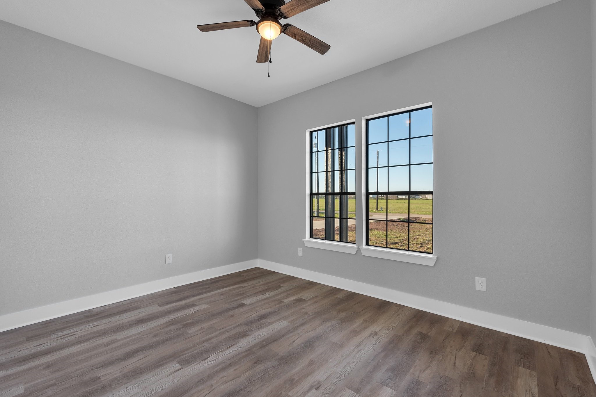 519 Chuckwagon Trail Angleton, TX 77515 - Photo 24 of 34 a view of an empty room with a window and wooden floor