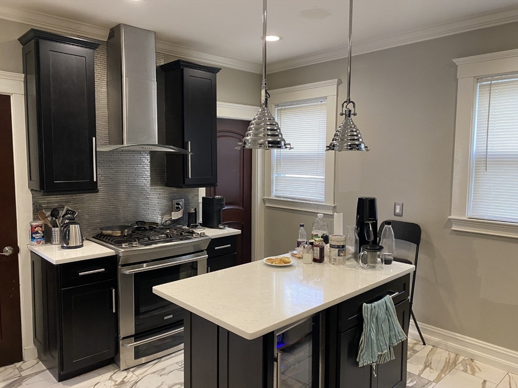 19 Pleasant Street, Unit 1 Boston, MA 02125 - Photo 1 of 10 a kitchen with a sink a stove and refrigerator