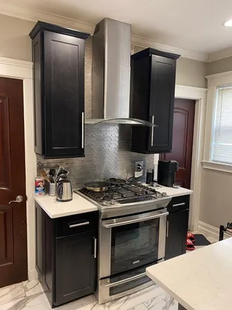 a kitchen with a stove and a refrigerator