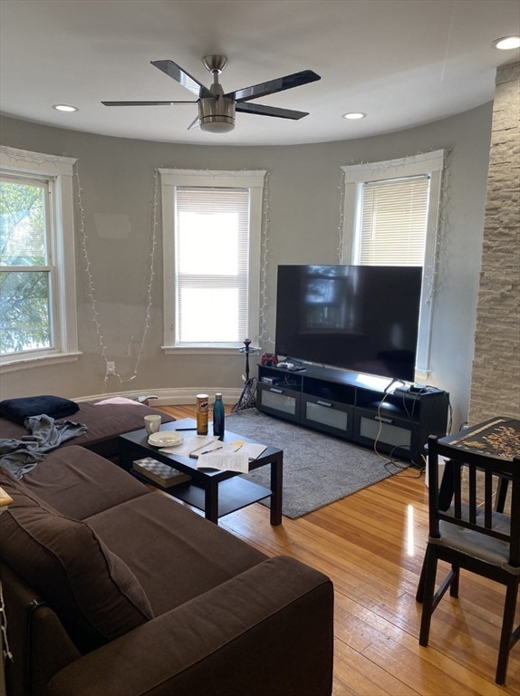 19 Pleasant Street, Unit 1 Boston, MA 02125 - Photo 4 of 10 a living room with furniture and a flat screen tv