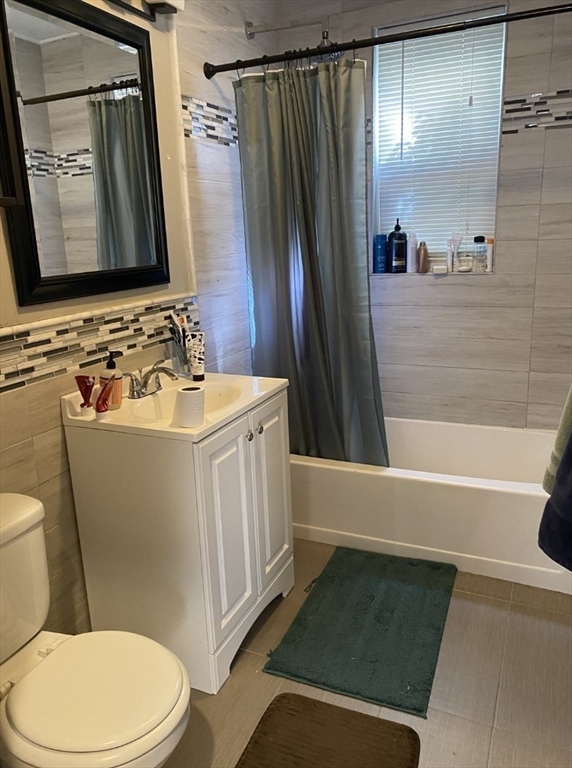 19 Pleasant Street, Unit 1 Boston, MA 02125 - Photo 5 of 10 a bathroom with a sink toilet and shower