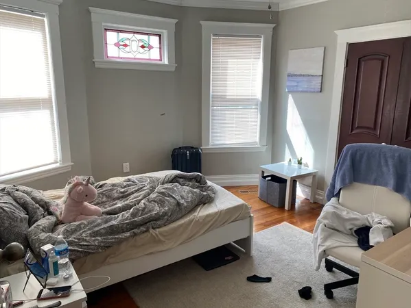a bedroom with a bed and window