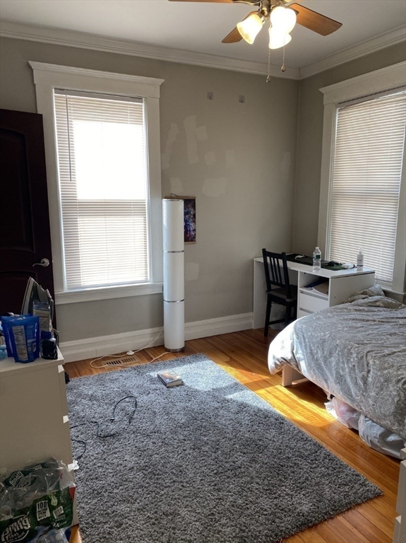 19 Pleasant Street, Unit 1 Boston, MA 02125 - Photo 8 of 10 a bedroom with a bed and a window