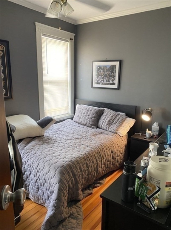 19 Pleasant Street, Unit 1 Boston, MA 02125 - Photo 9 of 10 a bedroom with a bed and lamp