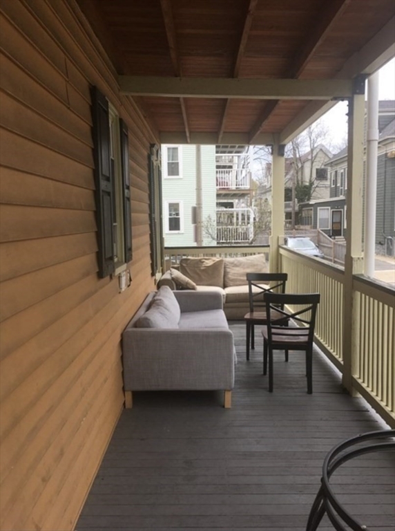 19 Pleasant Street, Unit 1 Boston, MA 02125 - Photo 10 of 10 a balcony with furniture and wooden floor