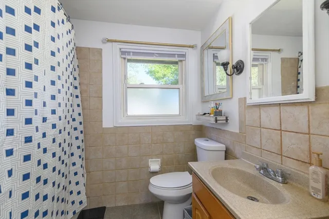 a bathroom with a sink toilet and mirror