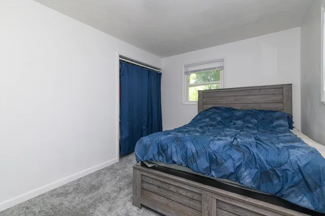 a bed sitting in a bedroom next to a window