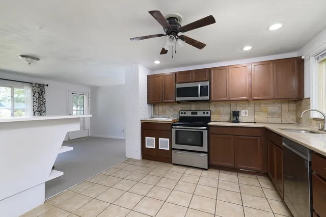 a kitchen with stainless steel appliances granite countertop a stove cabinets and a sink