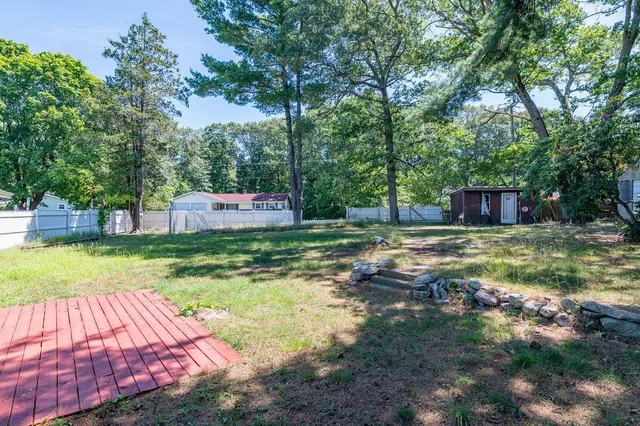 a backyard of a house with yard and trampoline