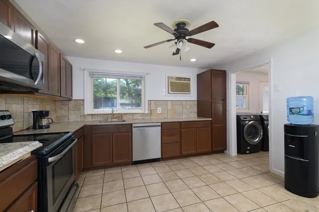 a kitchen with a stove a sink and a microwave