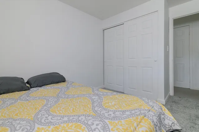 a bedroom with a bed and hallway