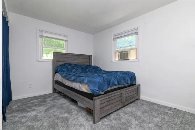 a bed sitting in a bedroom next to a window