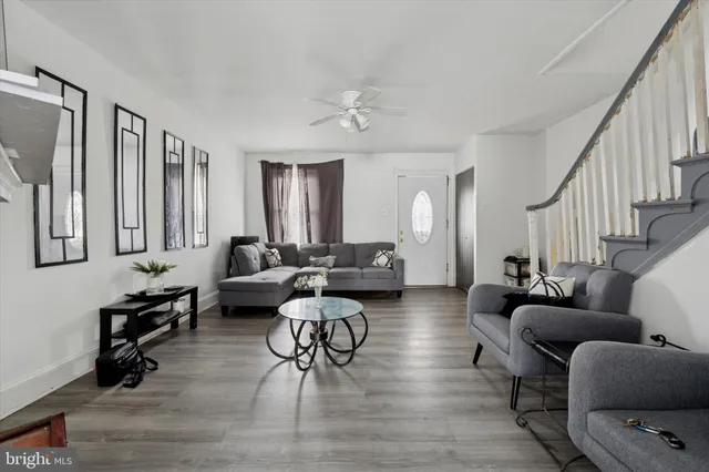 a living room with furniture and a wooden floor