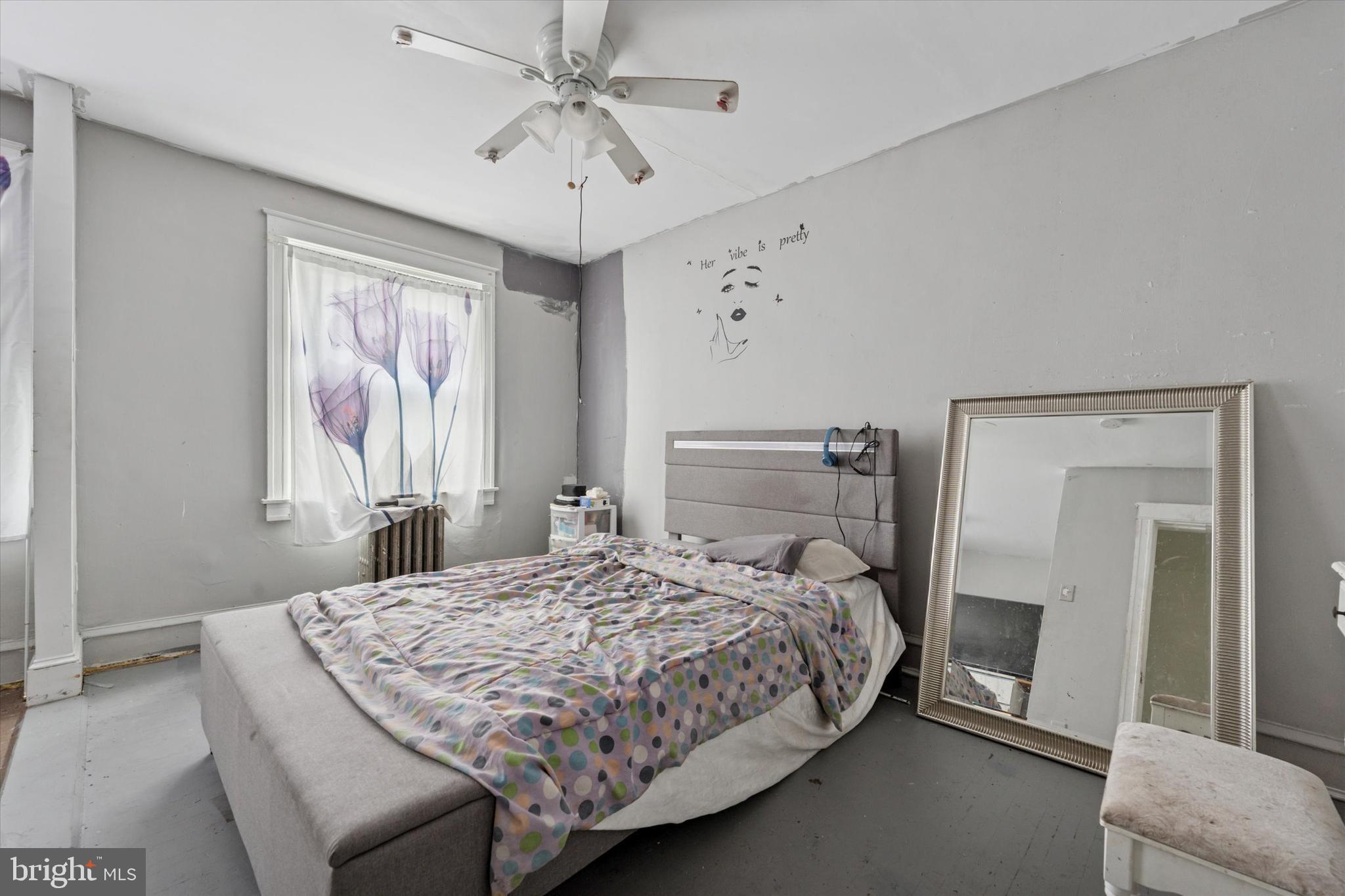 219 Laurel Road Sharon Hill, PA 19079 - Photo 3 of 15 a bedroom with a large bed and a chandelier