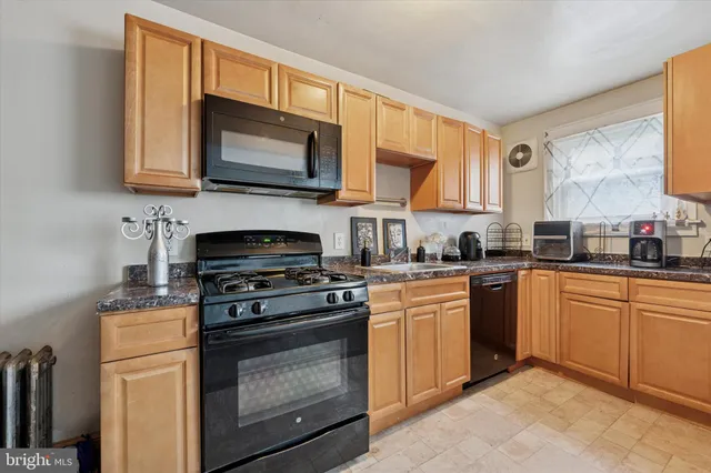 a kitchen with stainless steel appliances granite countertop a stove microwave and sink