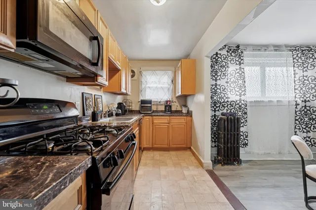 a kitchen with a stove a sink and a refrigerator