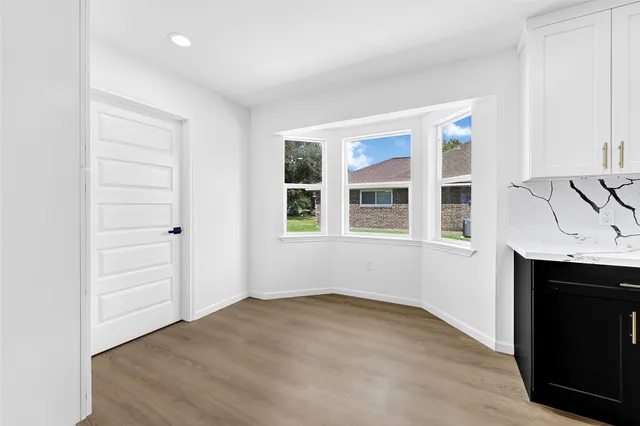 a view of empty room with window and fireplace