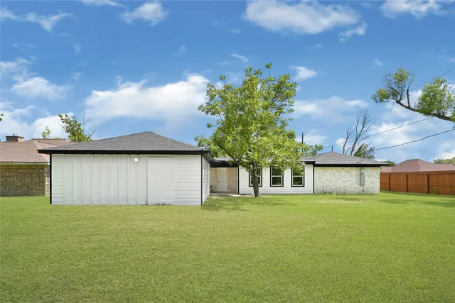 a front view of house with yard and trees