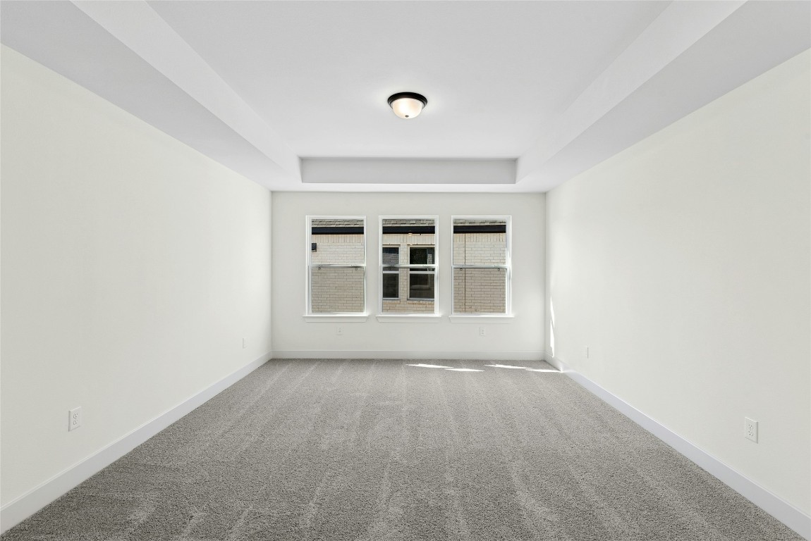 1533 Rodeo Ridge Drive Georgetown, TX 78628 - Photo 18 of 34 Empty room with carpet flooring and a tray ceiling