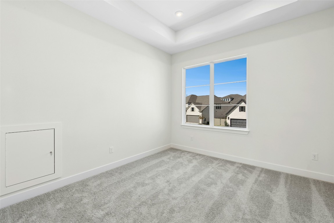 1533 Rodeo Ridge Drive Georgetown, TX 78628 - Photo 20 of 34 Carpeted empty room with a tray ceiling and recessed lighting